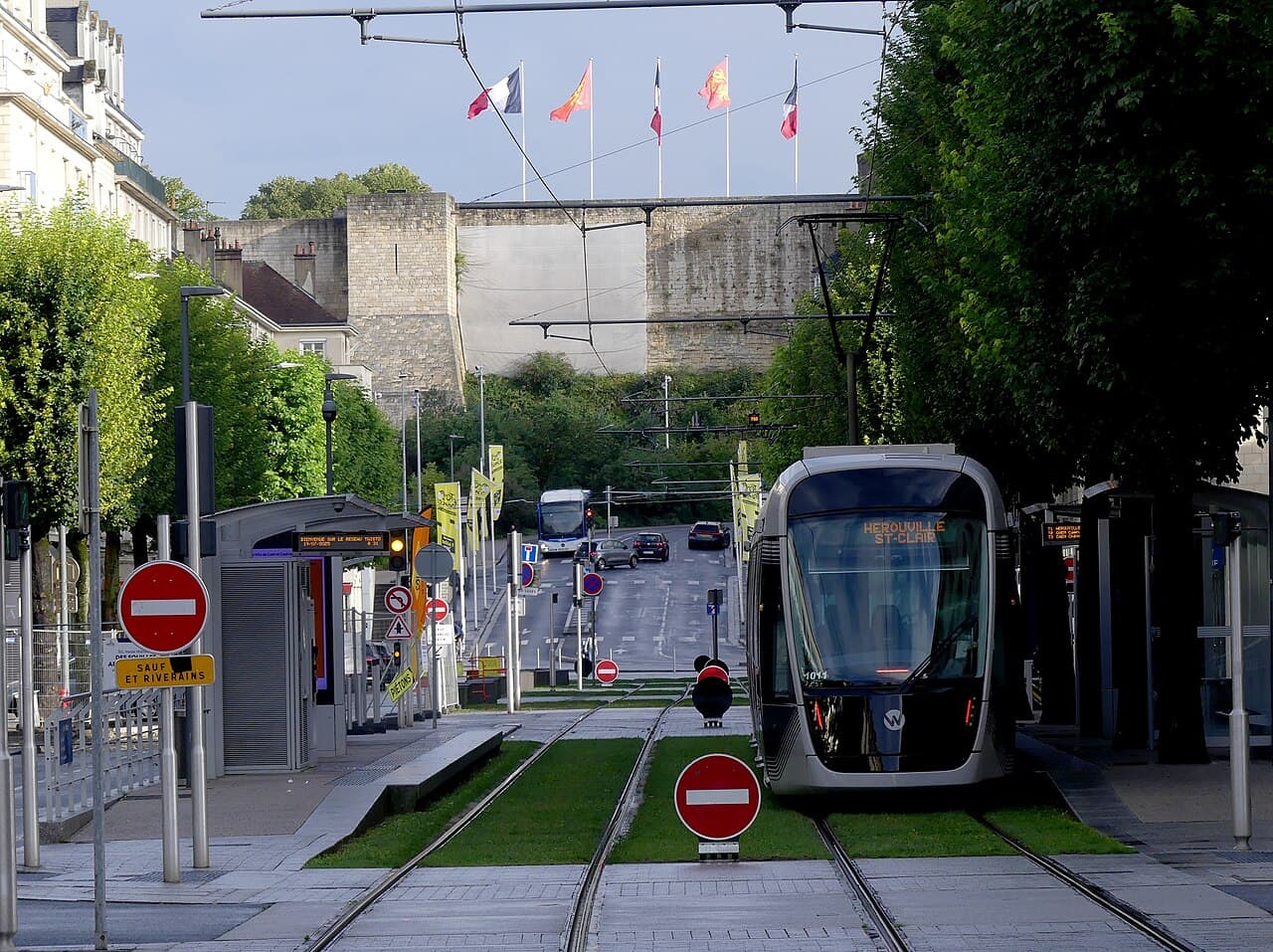 A tram in central Caen at first light, below the ramparts of the ducal castle