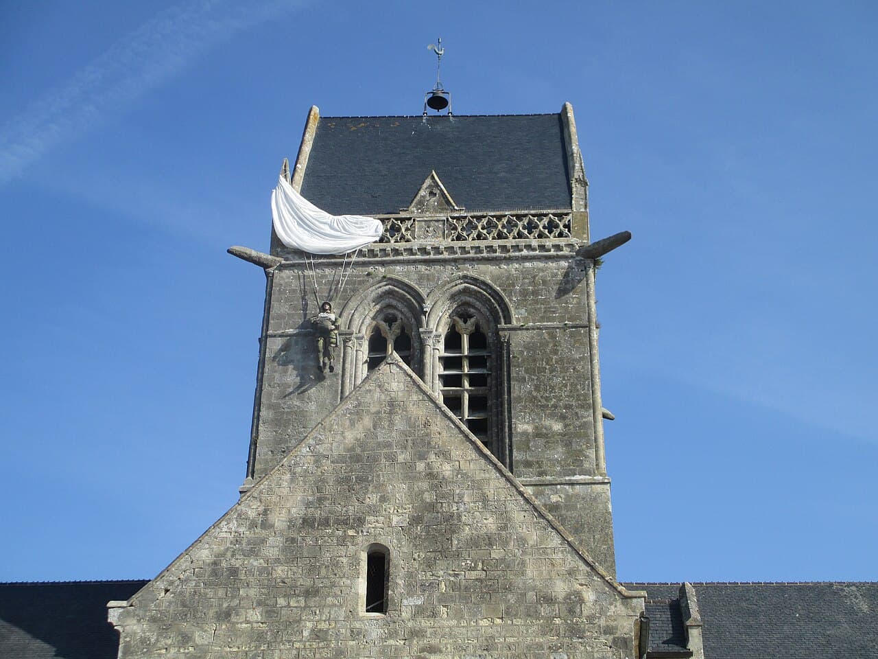 Church tower of Sainte-Mère-Église, with the paratrooper effigy commemorating John Steele