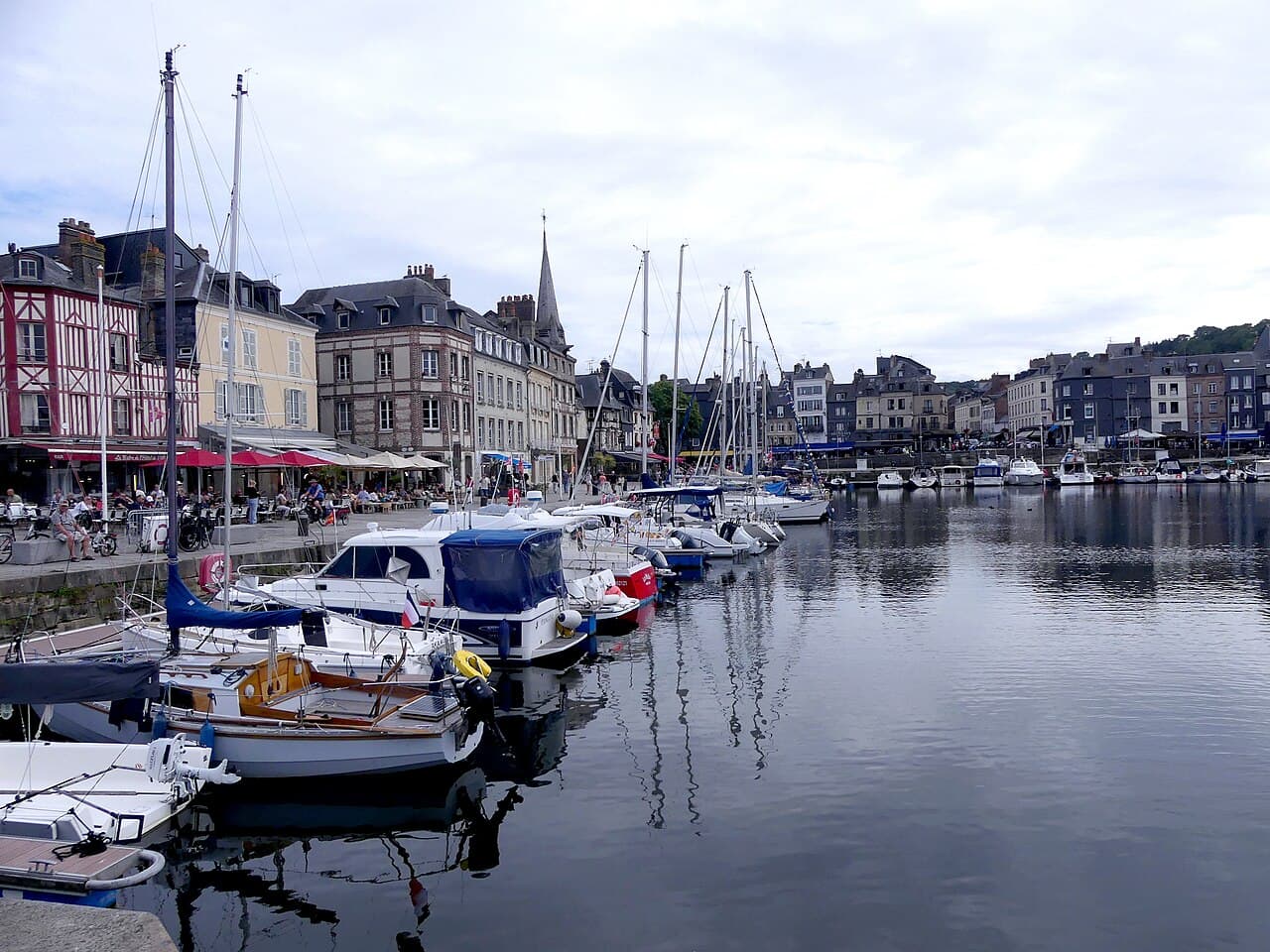 Sailing boats moored in the Vieux Bassin of Honfleur, in front of the tall houses of Quai Sainte-Catherine
